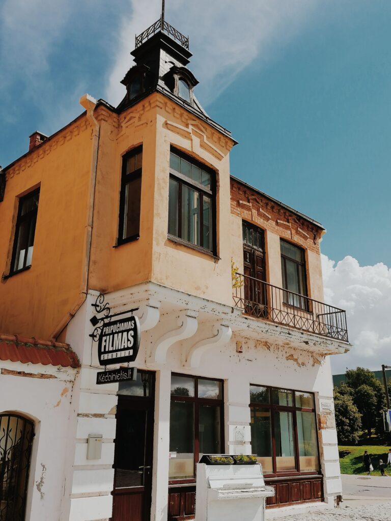 Charming vintage building exterior with distinct architectural style under clear sky.